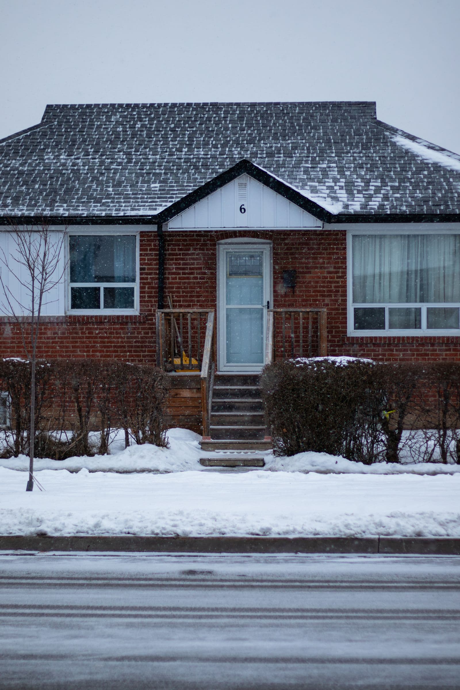 A snow-covered Ontario home with a cleared path to the front door.